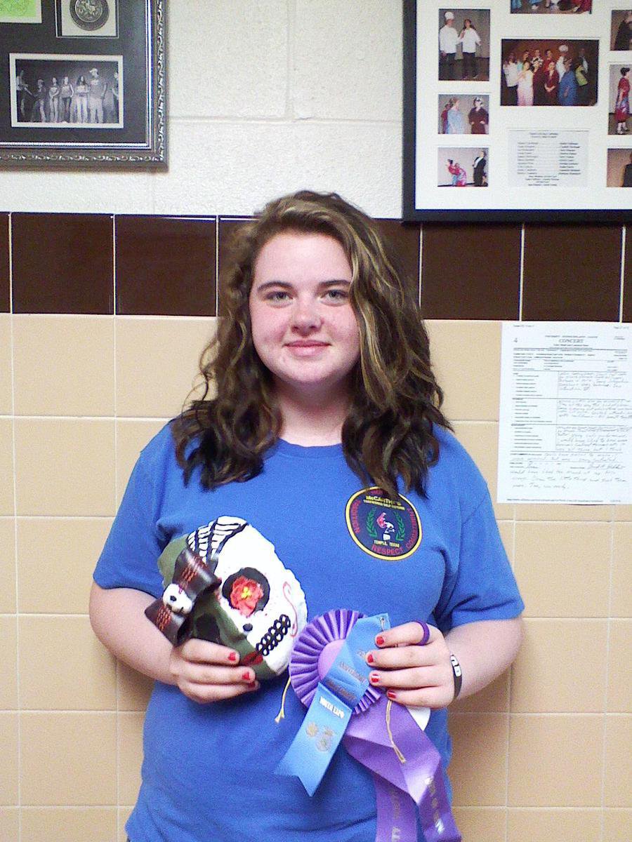 Image: Kylee Dabney displays her Clay Sugar Skull Mask and ribbons