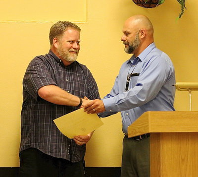 Image: Assistant band director David Graves is awarded a certificate for his efforts and accomplishments with the Italy Junior High Band with Principal Lee Joffre doing the honors.