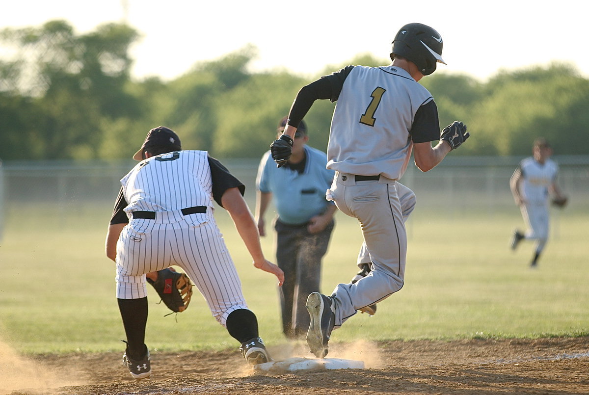 Image: Italy’s Levi McBride(1) out races the throw to first-base.