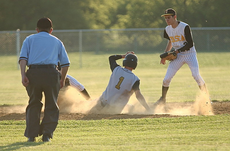 Image: Levi McBride(1) then slides safely into second-base(1) with Itasca struggling to slow the sophomore down.