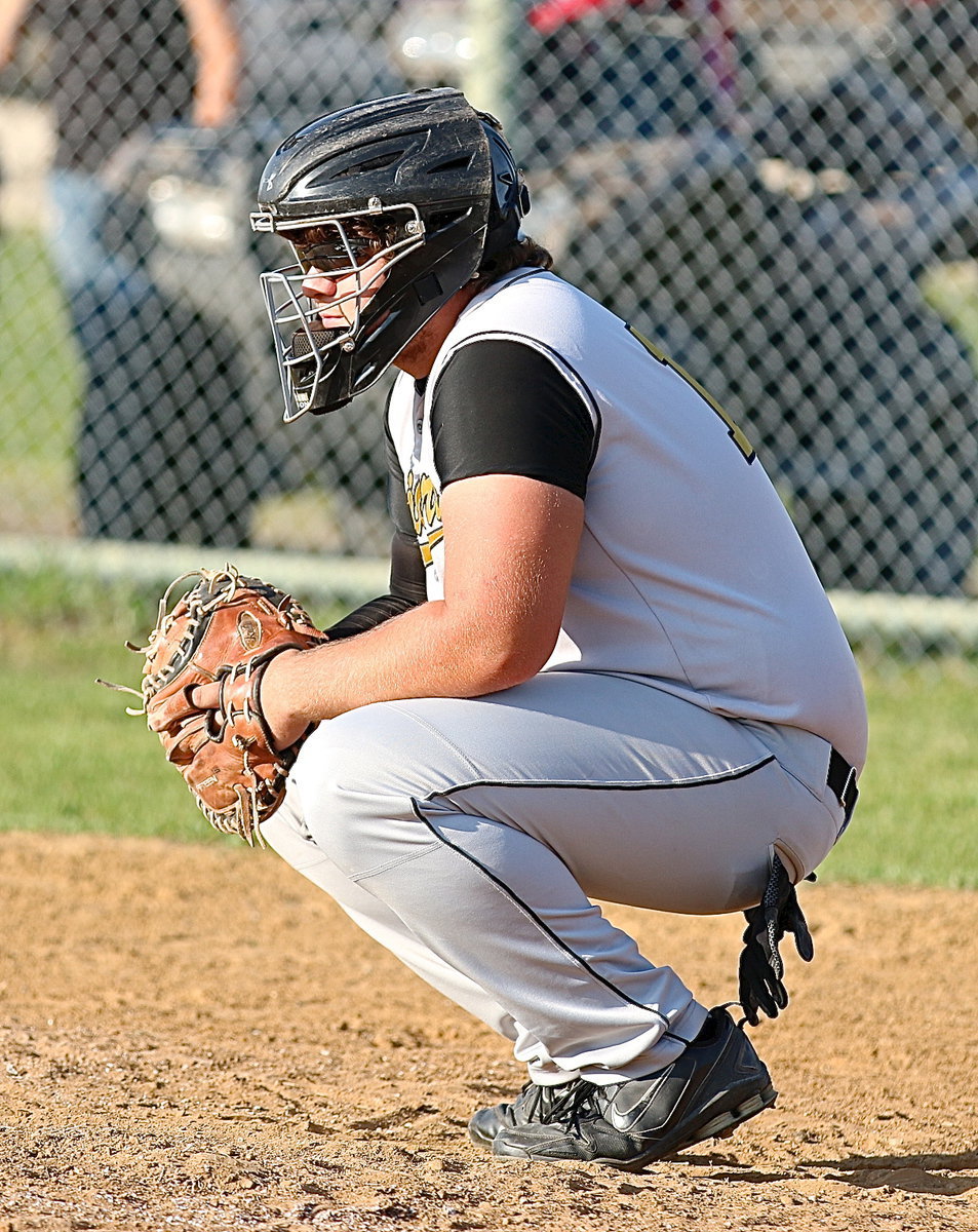 Image: Kevin Roldan(16) helps warmup his pitcher Ty Windham.