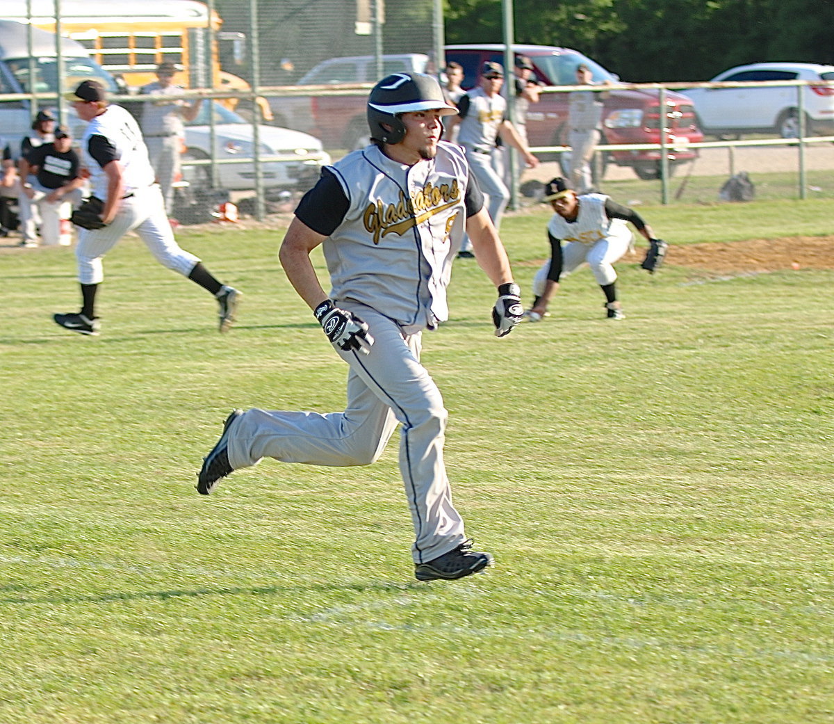 Image: Tyler Anderson(9) tries to beat the throw to first-base.