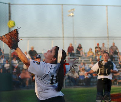 Image: The lone senior for the Lady Gladiators Paige Westbrook(10) goes after a foul ball near the fence.
