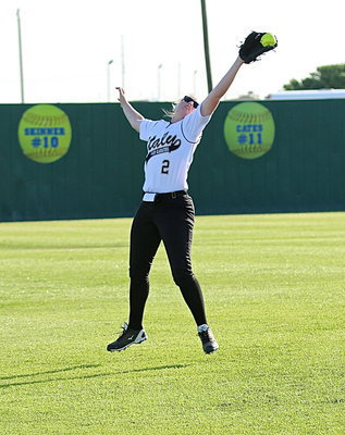 Image: Madison Washington(2) attempts to catch the relay throw from the outfield.