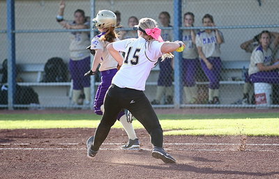 Image: Jaclynn Lewis(15) fields a bunt down the first-base line and then throws the runner out at the bag.