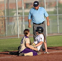 Image: Lady Gladiator Lillie Perry(9) slides into third-base and draws a safe sign from the ump after he takes a closer look.