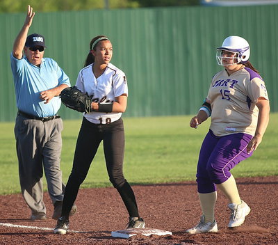 Image: April Lusk(18) checks the infield after getting a force out at third.