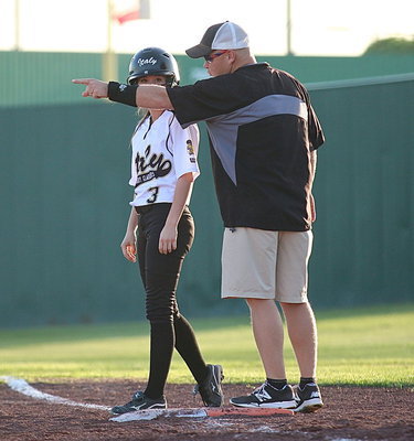 Image: Lady Gladiator first-base coach Michael Chambers directs pinch runner Cassidy Childers(3).