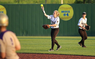 Image: Kelsey Nelson(14) hurries the throw in from the outfield with second-baseman Bailey Eubank(1) out there backing up the play.