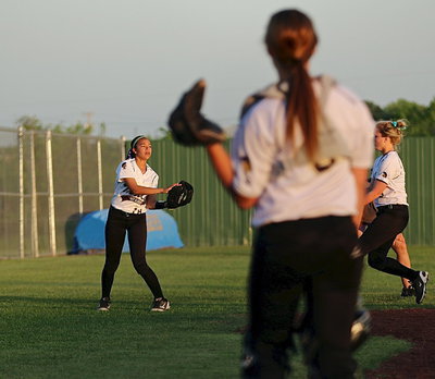 Image: April lusk(18) catches a pop-up in foul territory for the Lady Gladiators.