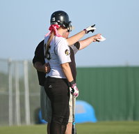 Image: Lady Gladiator head coach Wayne Rowe appears to be asking Jaclynn Lewis(15) to hit one over the centerfield wall…