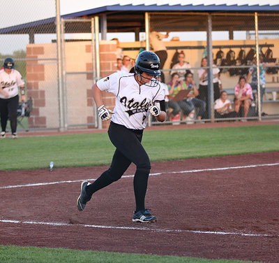 Image: Lillie Perry(9) hits and then hurries to first-base.