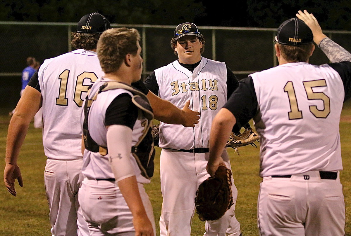 Image: John Byers(18) gets congratulated by his teammates after pulling off a game-ending double-play to secure Italy’s 12-4 district win over Frost.