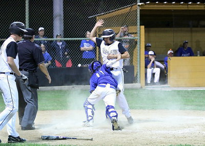 Image: Tyler Anderson(11) collides with the Frost catcher, the ball gets away and Anderson scores the run for Italy.