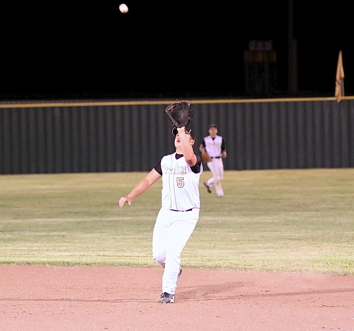 Image: Gladiator senior Zain Byers(5) gets under a popup between first and second-base for an out late in the contest against Frost.