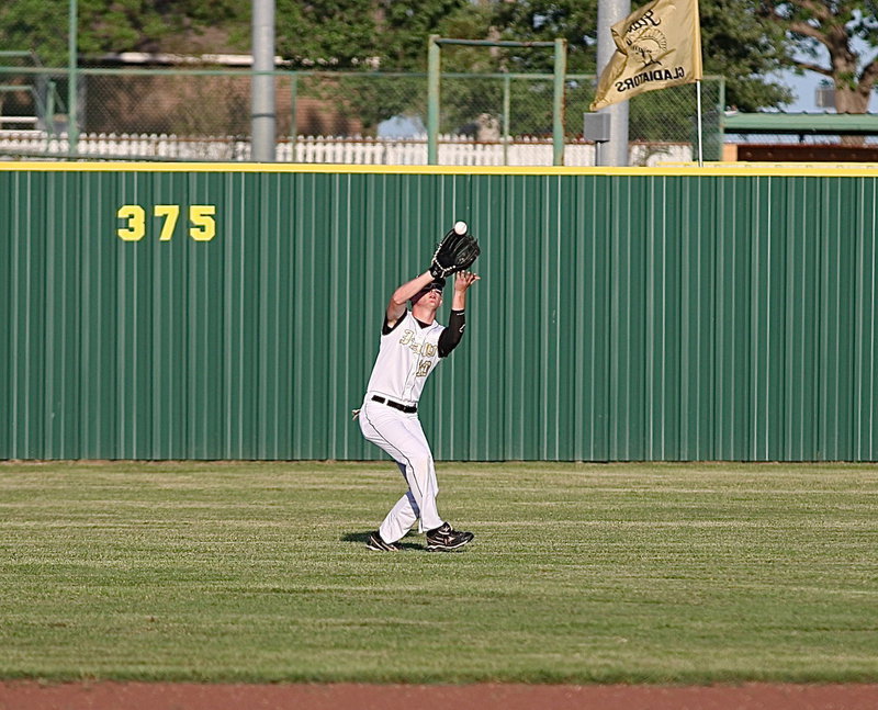 Image: Left fielder Cody Boyd(10) uses both hands to secure a pop fly hit by the Polar Bears.