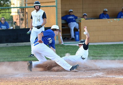 Image: Tyler Anderson(11) slides home safely after a wild pitch by Frost as teammate Kyle Fortenberry(14) gives his teammate room to work.
