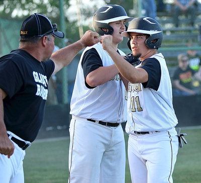 Image: Assistant coach Jackie Cate and fellow senior Bailey Walton(17) congratulate Tyler Anderson(11) after Anderson scored a run for Italy.