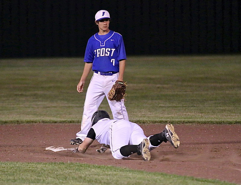Image: A head first dive propels John Escamilla(7) safely into second-base.