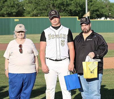 Image: Gladiator Baseball senior Zain “Zilla” Byers(5) is proudly escorted out by his grandmother, Ann Byers, and his father, Barry Byers, for Zain’s final home game at Davidson Field in Italy.