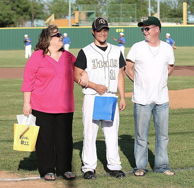 Image: Gladiator Baseball senior Tyler Anderson(11), aka The Fiery Midget,  is proudly escorted out by his mother, Amy Anderson, and his father, Steve Anderson, for Tyler’s final home game at Davidson Field in Italy.