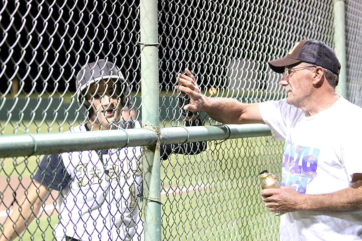 Image: Levi McBride(7) receives a love tap from his father Darrell McBride after Levi completes his second home run lap of the season during a 12-4 win over Frost. No fences here.