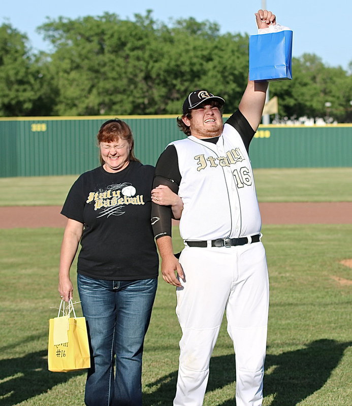 Image: Gladiator Baseball senior Kevin “Big Agua” Roldan(16) rejoices in the glow of Senior Day as proud, but flustered mom, Flossie Gowin, bravely escorts her son out for his final home game at Davidson Field in Italy.