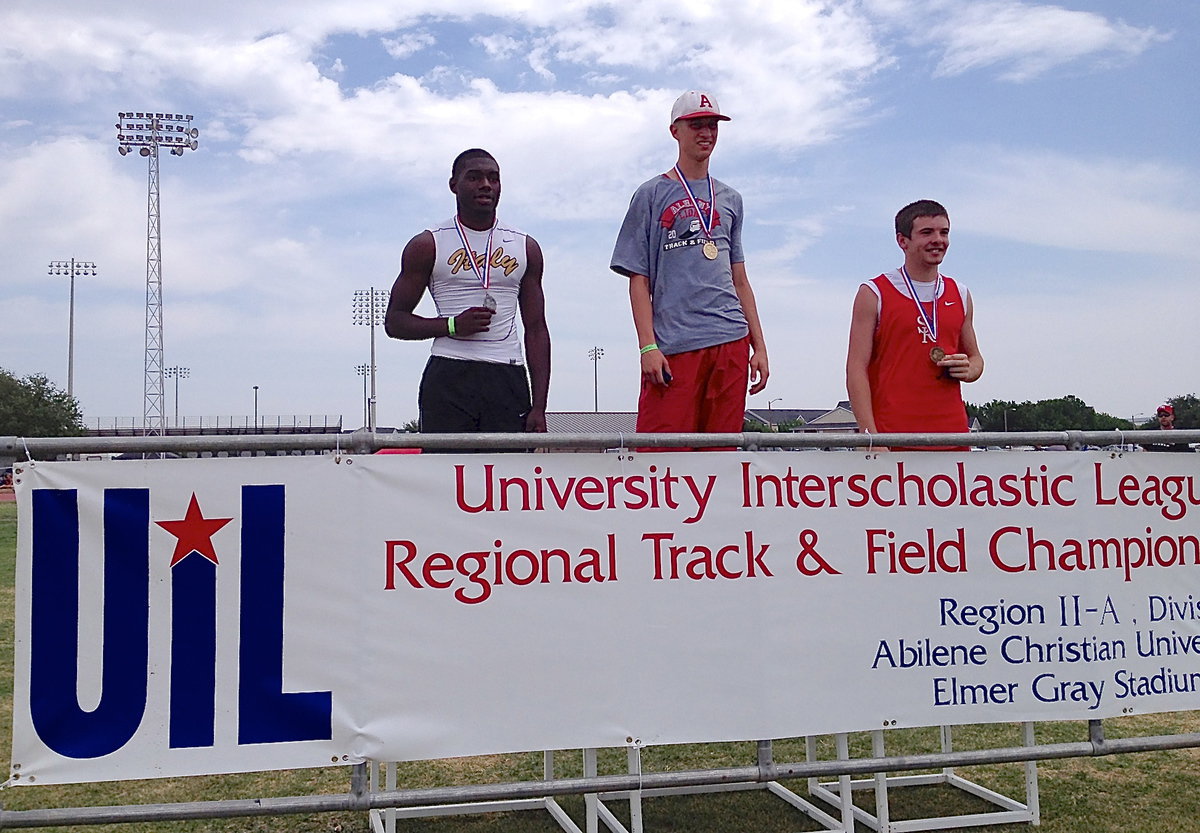 Image: Italy Gladiator senior TaMarcus Sheppard achieving (Left) is presented his silver medal at the champions’ podium after achieving a personal best in the high jump of 6’,3" during the UIL Regional Track And Field Championship in Abilene at the Abilene Christian University campus.