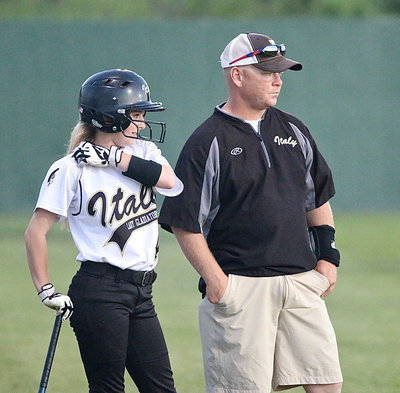Image: Britney Chambers(4) with a solid performance against Mart chats with father/coach Michael Chambers before taking another turn at bat.