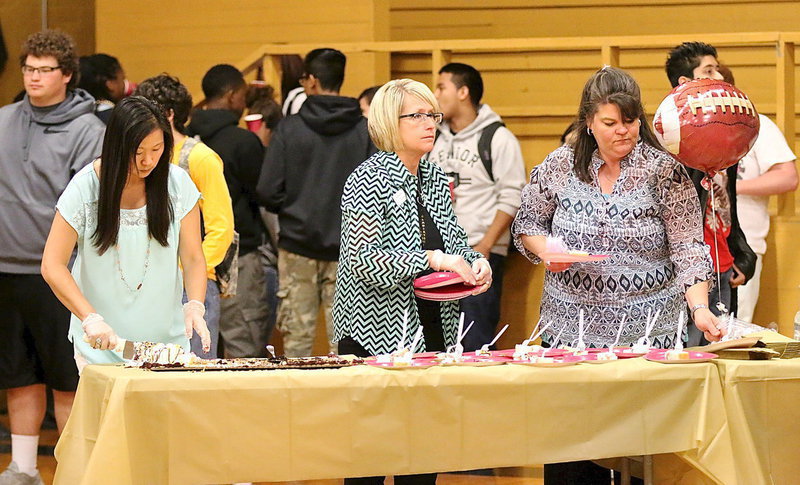 Image: Serving the students during the signing party are Nicole Tindol, Lisa Jacinto and Nancy Byers.
