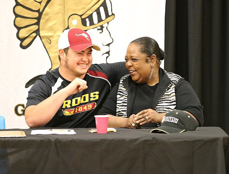 Image: Zain Byers and Italy ISD teacher Vivian Moreland have a laugh during Zain’s signing party.