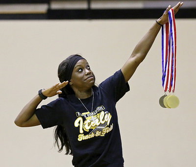 Image: Kortnei Johnson strikes the Lady Gladiator pose with her three medals displayed at the end of her symbolic sword of victory!