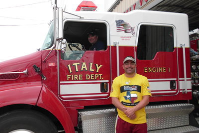 Image: Adam Mysiuk of the Pompono Beach, Florida Fire Rescue squad visits with Italy Firefighter J.D. Cate.