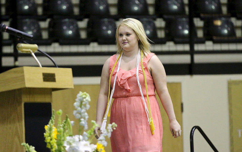 Image: Jesica Wilkins returns to the stage to accept her Cosmetology Certification.
