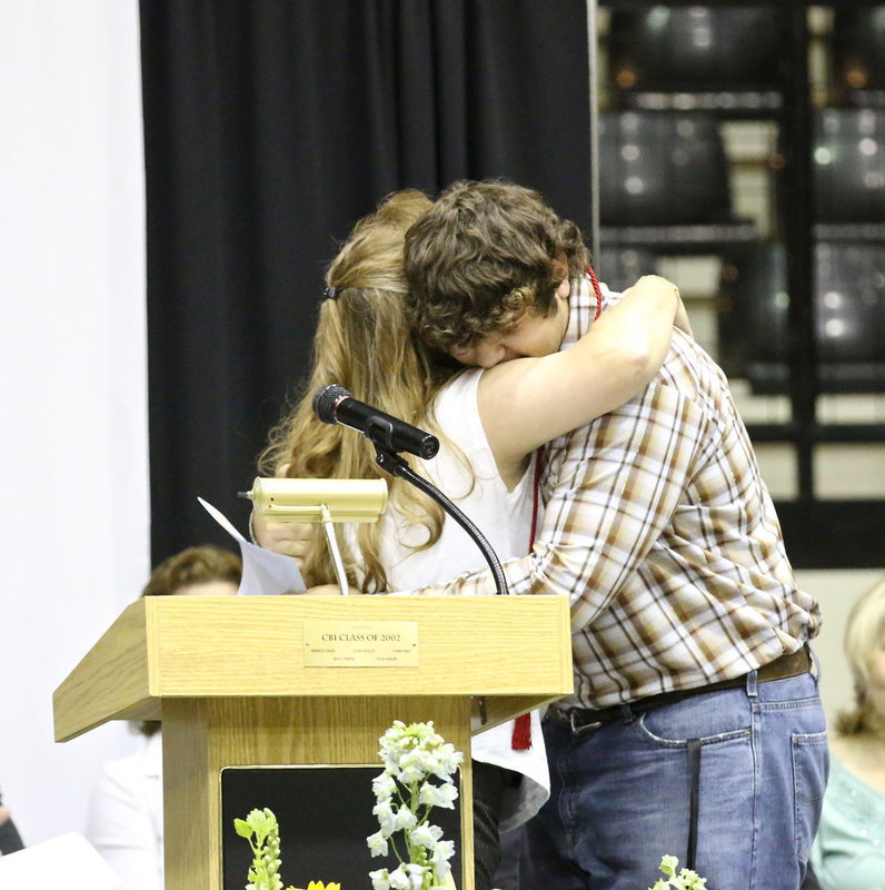 Image: Flossie Gowin hugs Lion Club scholarship recipient, and son, Kevin Roldan. Joseph Sage, Emily Stiles and Taylor Turner were also recipients.