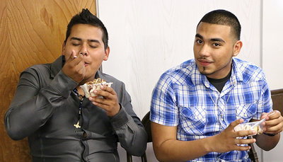 Image: Good stuff! Javier Enriquez and Reynaldo Salas are taking on the ice cream one bite at a time.
