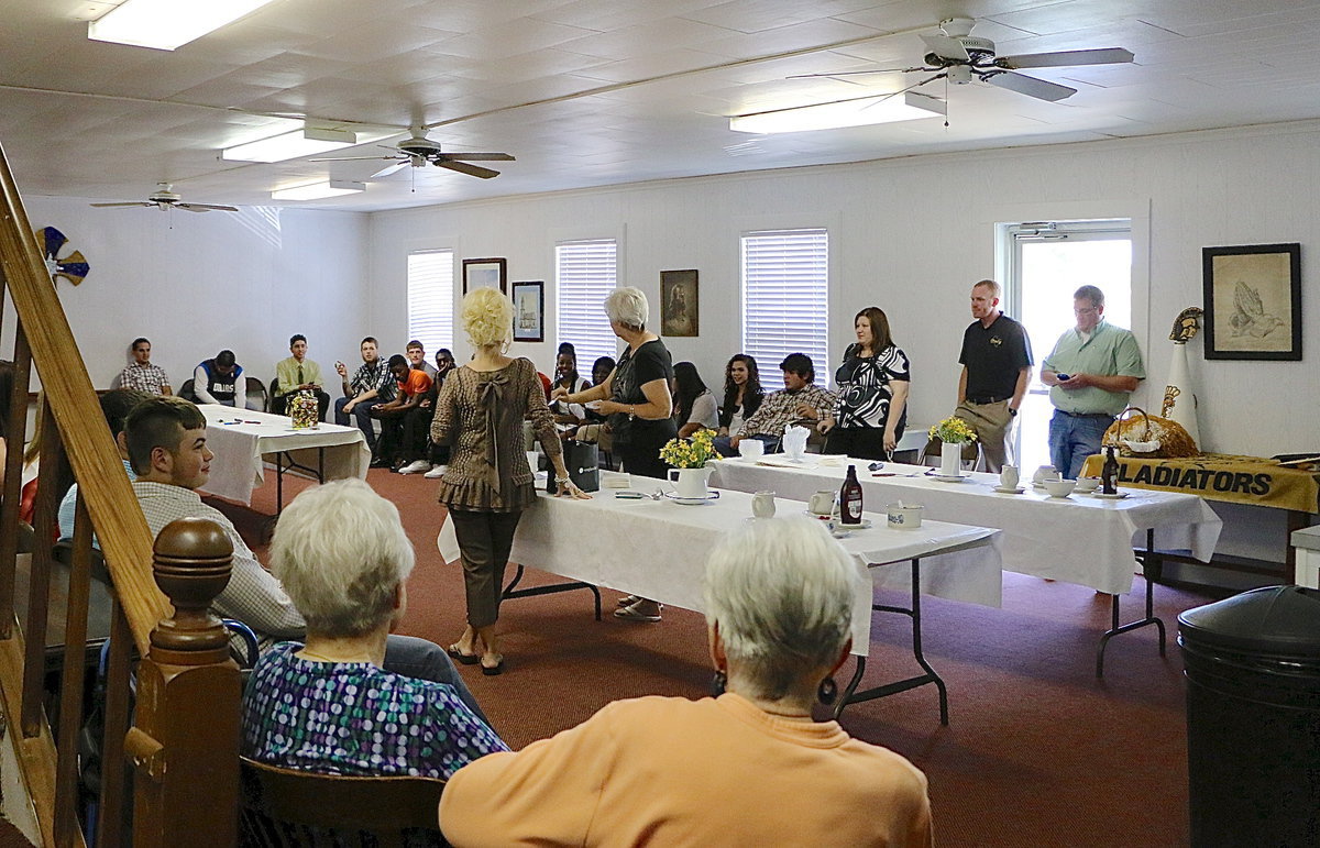 Image: Church members Barbara Chambers and Alice Thompson oversee the White Elephant game hosted by the Methodist Church for Italy High School’s 2014 seniors.