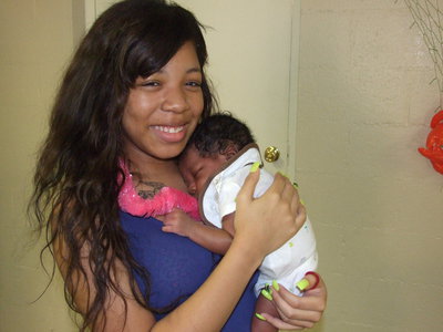 Image: Ryisha Copeland and six week old Baby Drake are excited for the party to begin.