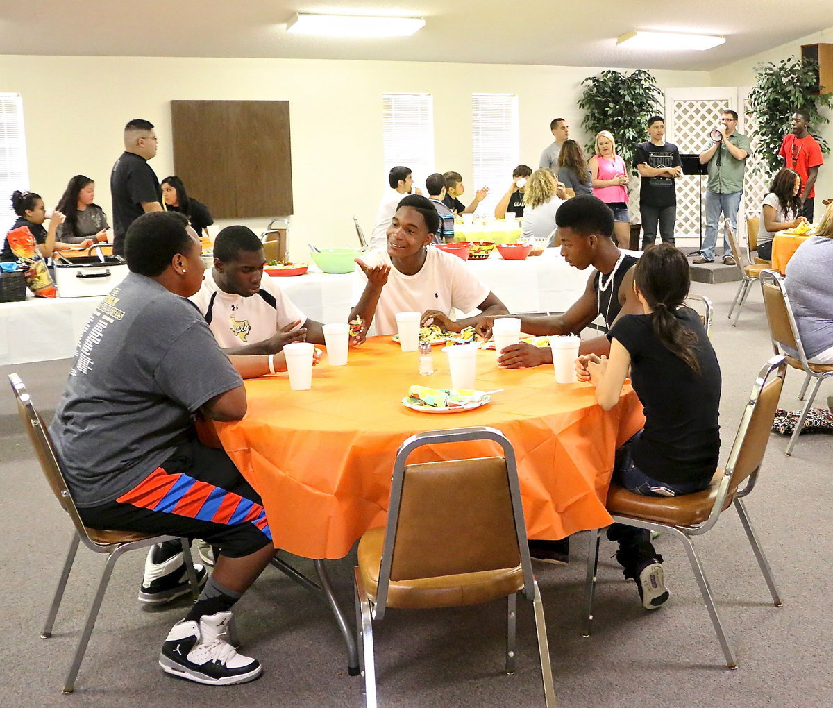 Image: Darol Mayberry, TaMarcus Sheppard, Trevon Robertson, Eric Carson and Johnny Campos discuss world events while playing the survival game.