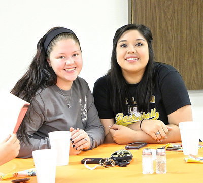 Image: Paige Westbrook and Monserrat Figueroa enjoy some of their final moments with their classmates.