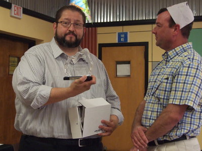 Image: Mr. Velasco gives Paul Cockerham a plaque of appreciation for six years of service.