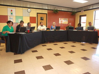 Image: The new school board sits together for the first time.