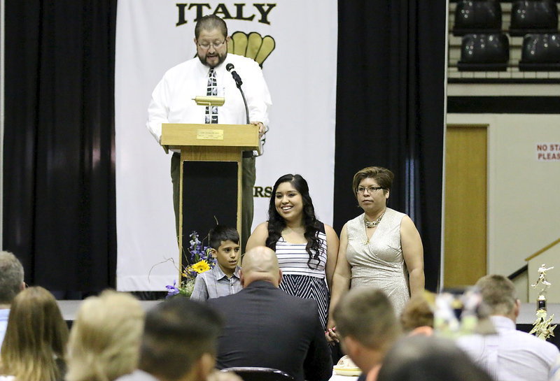 Image: In recognition of Italy’s 2013-2014 senior student-athletes, Monserrat Figueroa is introduced while being escorted by her mother and nephew.