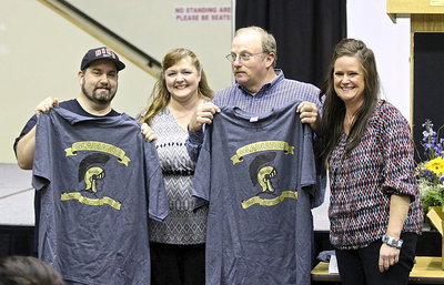 Image: Booster club representatives Flossie Gowin and Robbie Jones selected Ann Byers as the Gladiator Fan of the Year and presented her sons Barry Byers and Brentley Byers with the official T-shirts to wear in her honor. Guess it’s first-come-first-serve to the reserved parking spot…