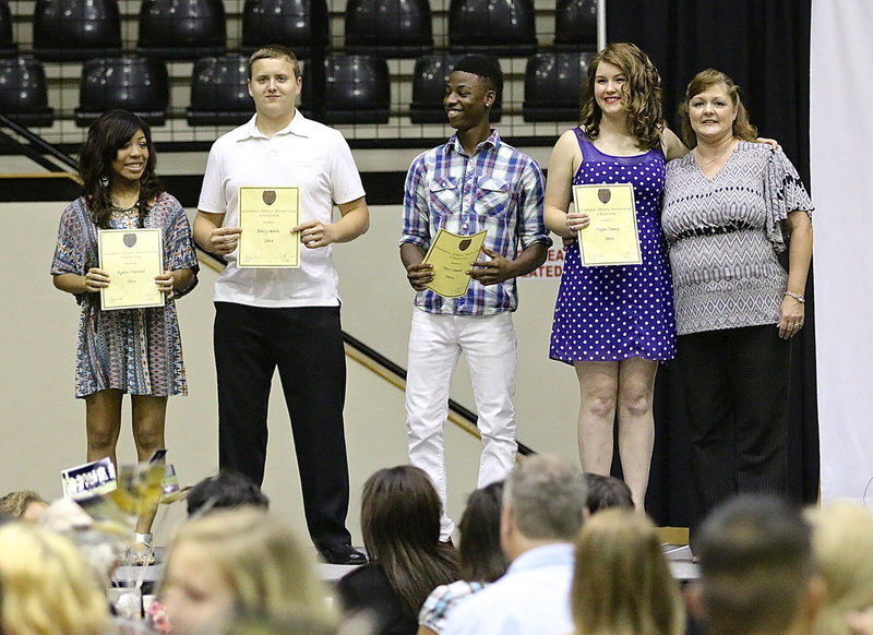 Image: Gladiator Athletic Booster Club President Flossie Gowin presented scholarships to Ryisha Copeland, Bailey Walton, Eric Carson and Taylor Turner.