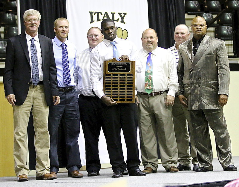 Image: TaMarcus “T” Sheppard is named Gladiator of the Year for 2013-2014 by the Italy Coaching Staff as Charles Tindol, Jon Cady, Brandon Ganske, Wayne Rowe, Jackie Cate and father/coach Bobby Campbell stand with pride around the chosen one.