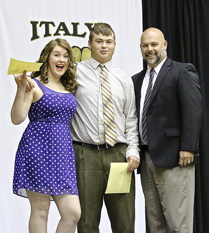 Image: Taylor Turner and Zain Byers are presented certificates for having the highest GPAs among senior athletes by Italy ISD Principal Lee Joffre.