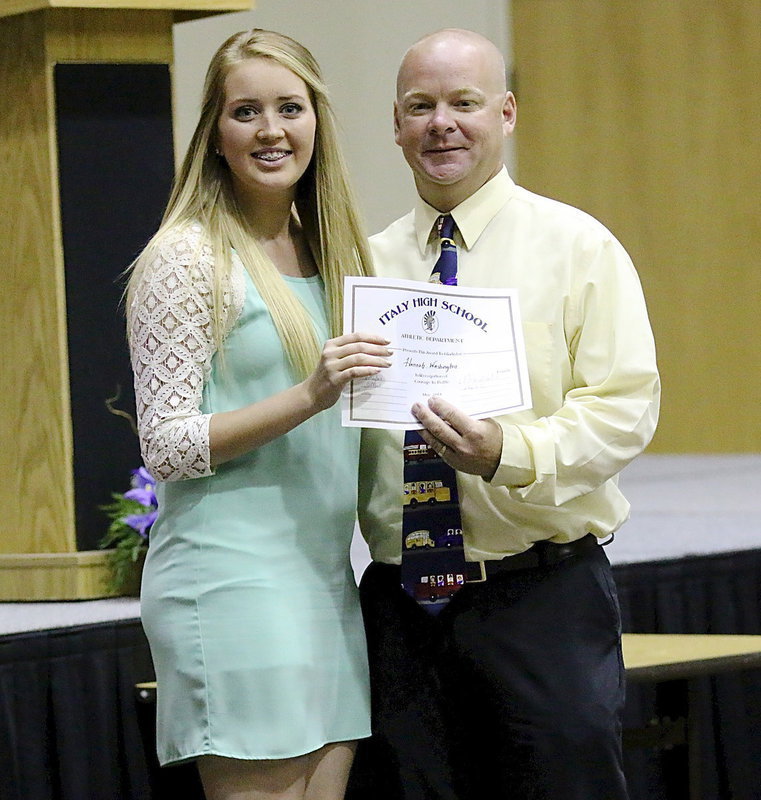 Image: Hannah Washington receives a sports participation certificate from Coach Michael Chambers with all athletes being recognized during the banquet.