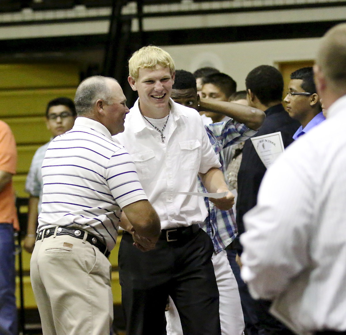 Image: Cody Boyd accepts his sports participation certificate from Coach Jackie Cate.