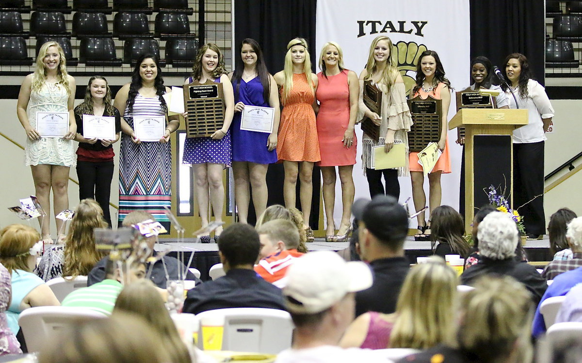 Image: The Lady Gladiator Volleyball team is honored as Jaclynn Lewis, Tara Wallis, Monserrat Figueroa, Taylor Turner (Fighting Heart Award), Paige Westbrook, Halee Turner, Head Coach Morgan Mathews, Madison Washington (Overall MVP), Bailey Eubank (Offensive MVP), Kortnei Johnson (Defensive MVP) and Assistant Coach Tina Richards stand proudly at the podium.